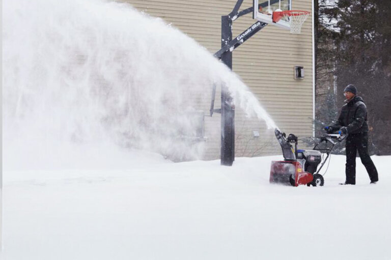 Toro SnowMaster snowblower throwing snow off a driveway