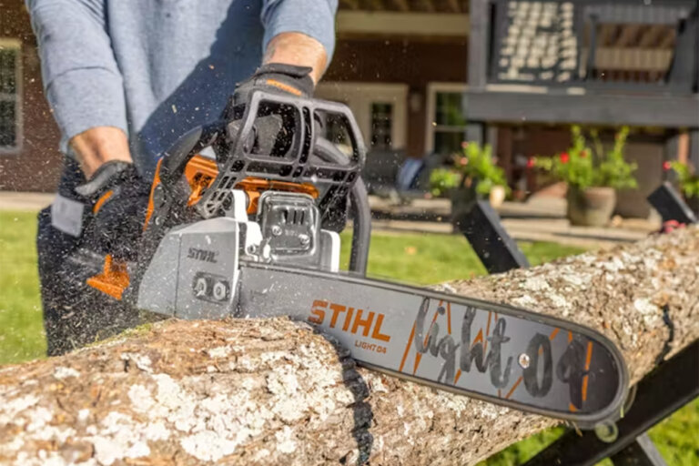 close up view of Stihl MS 250 chainsaw cutting a tree