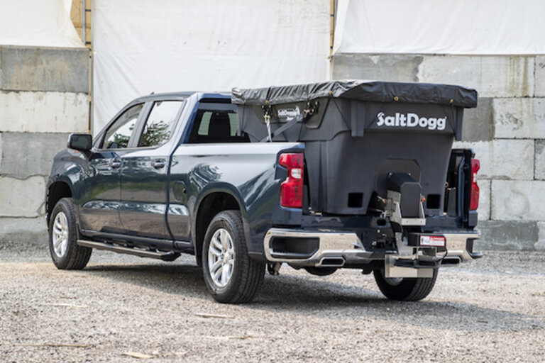 Black pickup truck with a SaltDogg SHPE2000 poly hopper salt spreader