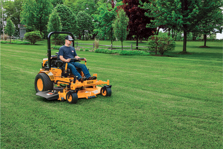 Man riding a Scag Turf Tiger II zero turn mower cutting grass