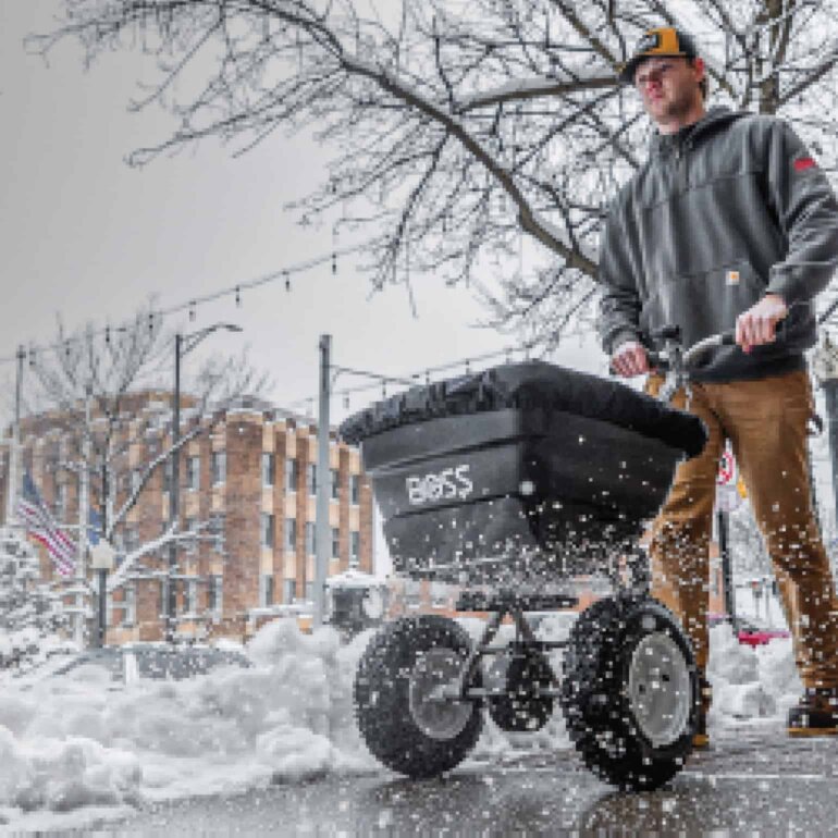 BOSS WBX walk behind spreader on sidewalk
