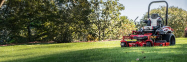 Exmark Lazer Z riding mower in back yard