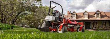 Exmark Radius zero turn mower in yard in front of house