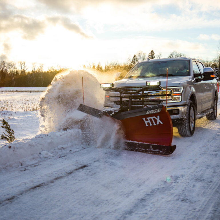 BOSS HTX v-plow clearing snow from a road