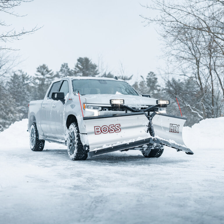 BOSS HTX v-plow with stainless steel blade on a white truck