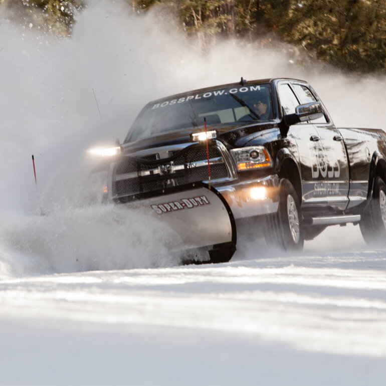 BOSS Super Duty snow plow clearing snow from a; road