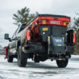 BOSS VBX salt spreader on the back of a pick up truck in a icy parking lot