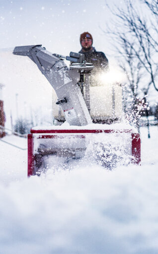 Ventrac sidewalk snow machine removing snow from a sidewalk