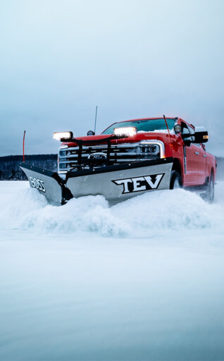 BOSS TEV v-plow snow plow on a red pick up truck plowing snow
