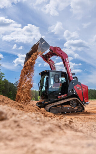 Yanmar track loader on a job site dumping dirt