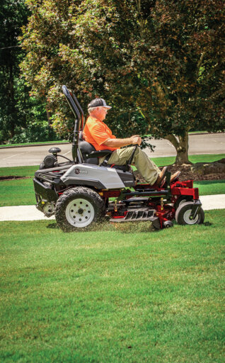 man on an Exmark zero turn riding mower cutting grass