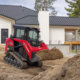 Man operating a Yanmar TL25RP track loader at a jobsite