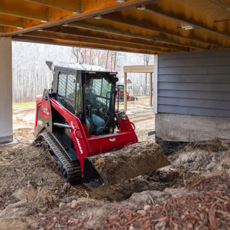 Man operating a Yanmar TL40RP track loader at a jobsite
