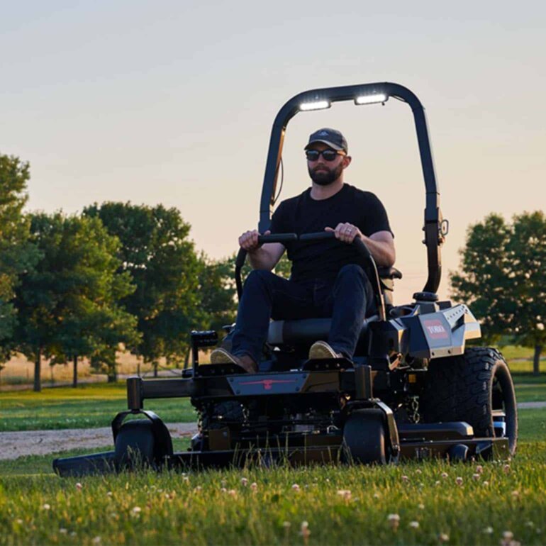 Toro zero turn riding mower model 76602 cutting grass