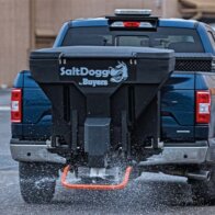 Salt Dogg salt spreader dropping salt in parking lot