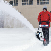 Toro Power Clear battery powered snow blower clearing driveway